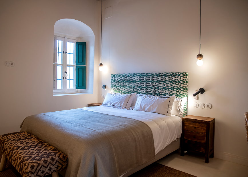 Double bed with upholstered headboard with green print