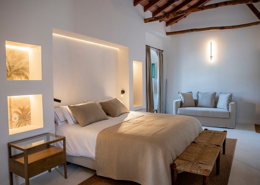 Spacious room with king size bed and sofa in the room.