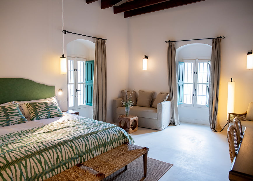Spacious room with king size bed, sofa and writing desk